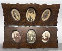 Two wooden photo frames with scalloped edges, each containing three oval-shaped vintage photos of men, women, and families, shown on a plain background.