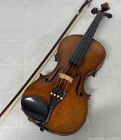 Violin and bow laid flat on floor