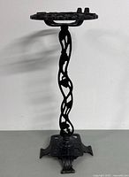 Full view of antique cast iron ashtray stand showing overall design and height.