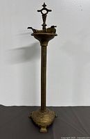 Full height view of brass floor standing ashtray