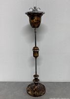 Overall view of standing ashtray showing cup, stem, and base