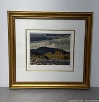 Full view of framed print showing matting and gold-tone wood frame