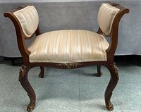 Front three-quarter view showing upholstery, wood frame, ormolu mounts, cabriole legs.
