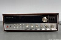 Front view showing wood casing and metal front panel with knobs and Harman Kardon 930 logo