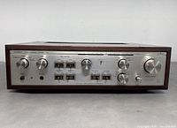 Front view of silver faceplate featuring volume, balance, bass, treble knobs, tone control switches and headphone jack.
