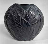 Front view of matte black crystal vase showing raised leaf-feather motif