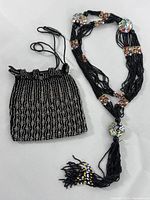 Photo of Victorian handmade black beaded necklace alongside matching beaded purse showing overall condition and details of beads and patterns