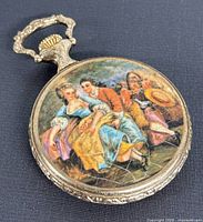 Front painted cover showing three 18th-century figures in period costume. Minor surface scratches visible.