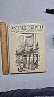 Front cover of the book showing the title 'Discover Toronto John Richmond's Illustrated Notebook' with detailed architectural drawing.