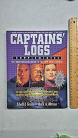 Front cover of the Captains' Logs Supplemental book showing title, author names, Star Trek characters and thematic colors.