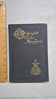 Front cover of the book showing black textured material with gold embossed title 'Rubaiyat of Omar Khayyam' and decorative ornament at bottom.