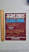Front cover of the book showing title, author names, and starship technical drawing.