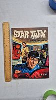 Front cover of Star Trek Annual 1974 comic book showing main characters and title with ruler for size reference.