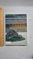Front cover of the book showing the title, author, and Japanese rock garden image.