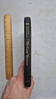 Spine of the hardcover book showing title 'The Last Tycoon' and author F. Scott Fitzgerald with a ruler for scale.