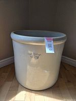 Full view of large off-white Imperial crock showing crown insignia and label