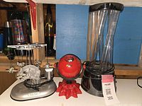 Full view showing all three items: the rotating airplane mobile on the left, the red laser projector light in the center, and the bubbling water lamp on the right.