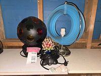 All three lamps displayed on shelf with blue background