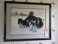 Framed art piece showing a boy in winter clothing with four dogs sitting in a snowy field, signed and numbered by Robert Duncan.