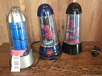 Overview photo showing all three motion-style lamps lined up on table, highlighting different themes and base colors