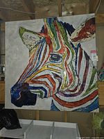Full view of square zebra head mural on canvas hung in storage space
