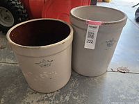 Two beige 3 gallon Imperial stoneware crocks with blue crown logos, showing wear and chips on rims.