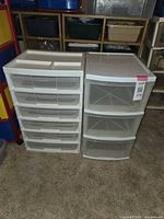 Photo of two white plastic storage carts side by side; one has five latch-lidded drawers, the other has three clear drawers.