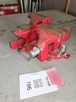 Wilton 6-inch red rotating workshop vise with swivel base showing profile and jaws.