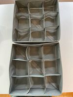 Photo of two grey fabric storage organizers showing multiple compartments made with fabric dividers