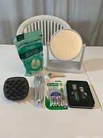 Full view of all self-care items together on white surface with chair in background.