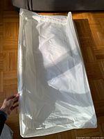 Top view of the white rectangular storage pad, showing the zippered removable cover.