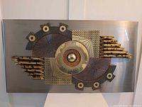 Full view of rectangular mixed metal wall sculpture