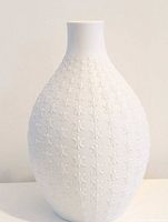 Full front view of white bisque relief vase