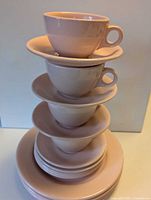 Stack of teacups, saucers and plates showing colour and style