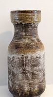 Front view of tall brown and white glazed Carstens vase