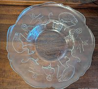 Top view showing entire glass console bowl with flamingo embossing and scalloped edge