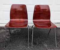 Front view of two Pagholz chairs showing molded plywood seats and chrome legs