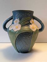 Front view of Roseville Dogwood vase showing floral relief and handles
