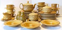 Full set showing plates, bowls, cups, teapot and accessories