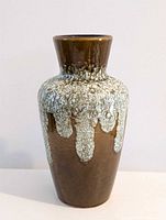 Front view of brown ceramic vase with white-green drip glaze