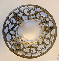 Top view showing ornate openwork brass plant stand