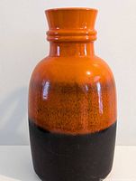 Front view of orange and black West German jug vase