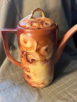 Front and side views of the vintage coffee pot showing the painted floral design and shape.