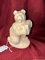 Front and side views of the USSR vintage white marble bear figurine holding an accordion, showing the detailed carving and marble texture.