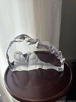 Front and side views of the heavy clear lead crystal glass sculpture depicting two walruses with detailed etched carving within a jagged iceberg-shaped glass form.