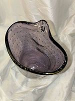 Top-down view showing the oval open top with bubble texture inside the purple glass, highlighting the curved rim detail.