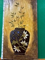 Full view of rectangular painting showing the vase and floral design on textured background