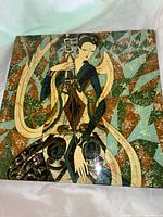 Front view of the serigraph showing the full artwork with the stylized female figure and abstract patterned background