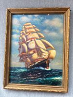 Framed print of a four-masted sailing ship on the ocean with detailed sails and sea waves.