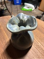 Front angled view of vintage gunny sack shaped pottery vase highlighting rim and glaze texture
